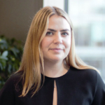 Image of smiling female bunker trader wearing a black blouse